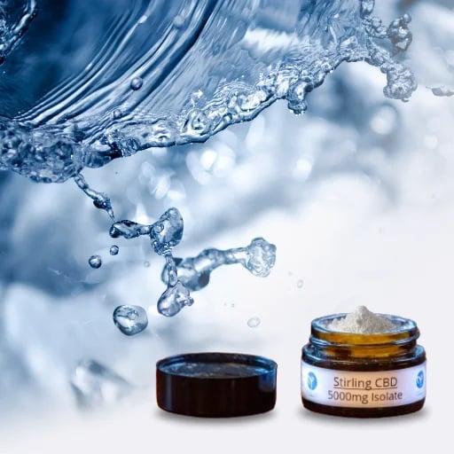A container labeled "Stirling CBD 5000 mg Isolate" is open with powder visible inside, set against a backdrop of water splashes.
